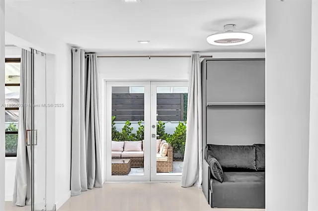 a living room with furniture kitchen view and a couch