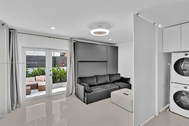 a living room with furniture a fireplace and kitchen view