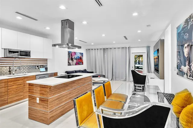 a view of kitchen with granite countertop stainless steel appliances and sink