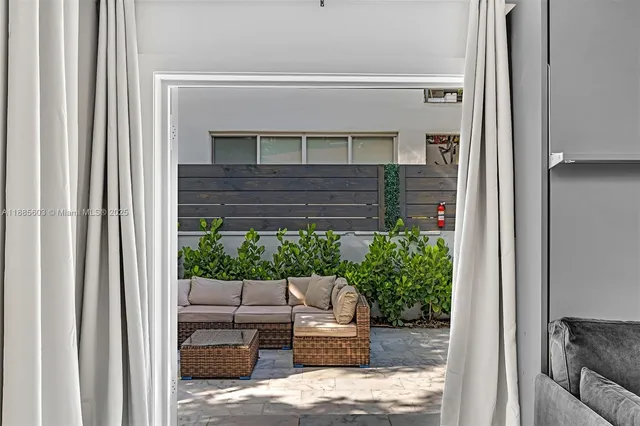 a view of a patio with furniture and a potted plants