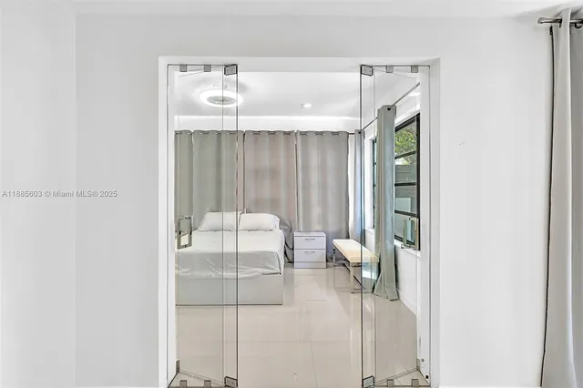 a bedroom with a large bed and a chandelier