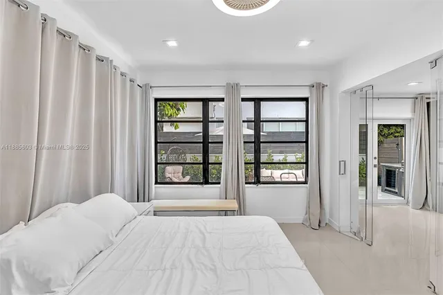 a bathroom with a sink and mirror with bathtub