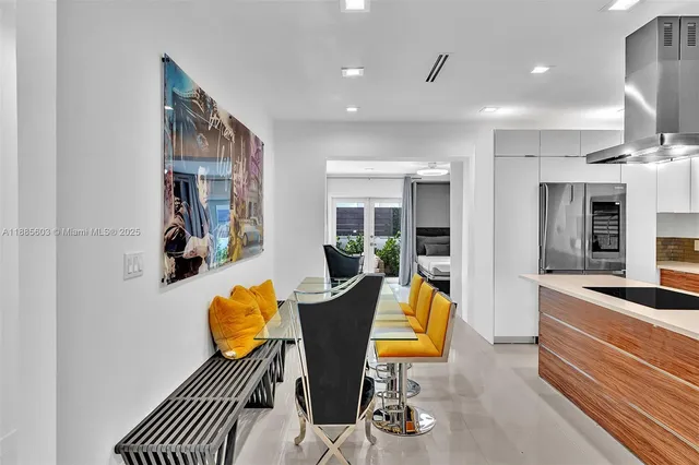 a living room with furniture and kitchen view