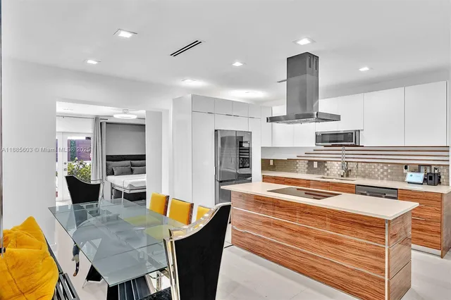 a kitchen with stainless steel appliances kitchen island granite countertop a sink and cabinets