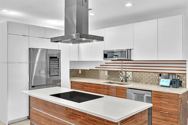 a kitchen with stainless steel appliances granite countertop a sink and a refrigerator