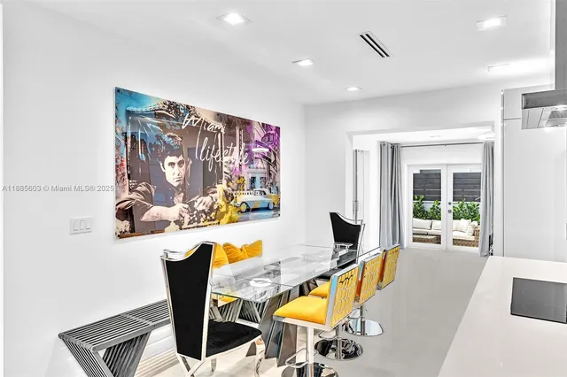 a room with stainless steel appliances kitchen island granite countertop a sink and cabinets