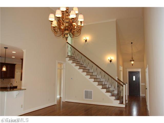 8902 West Pepper Court Oak Ridge, NC 27310 - Photo 16 of 16 Entry. This is a view from the Great Room looking toward the foyer. Note the dramatic ceilings and light fixtures. The floor plan is open and excellent for entertaining. Custom trim details are found throughout.