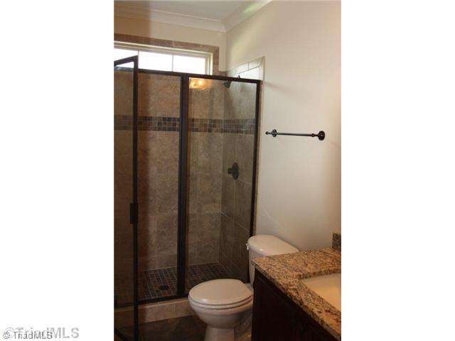 8902 West Pepper Court Oak Ridge, NC 27310 - Photo 12 of 16 Bath. The downstairs bath has a large shower with impressive tile work.
