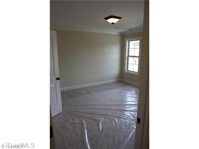 8902 West Pepper Court Oak Ridge, NC 27310 - Photo 13 of 16 3rd Bedroom. The crown molding continues in the upstairs bedroom.