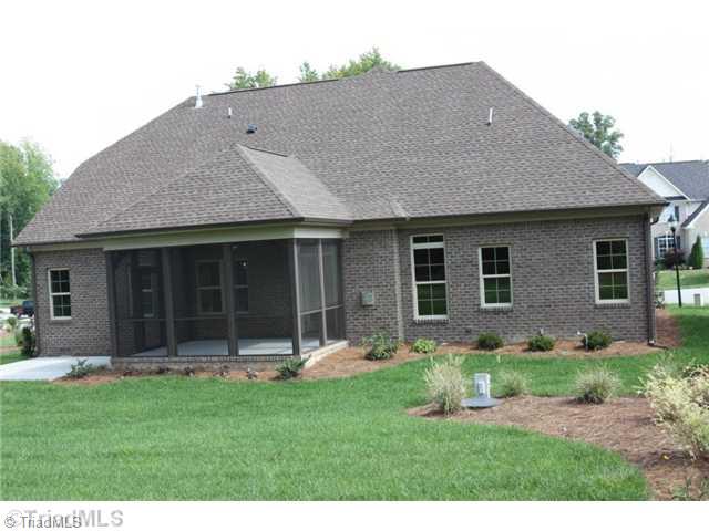 8902 West Pepper Court Oak Ridge, NC 27310 - Photo 15 of 16 Exterior Back. The sod and lush landscape continues in the backyard. In addition to the delightful screened porch, there is also a patio for grilling and enjoying the peace and beauty that is Hunters Mark.