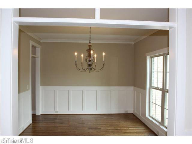 8902 West Pepper Court Oak Ridge, NC 27310 - Photo 2 of 16 Dining Room. The Formal Dining features custom wainscoting and nice transom detailing.