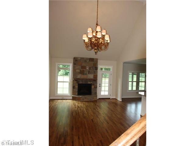 8902 West Pepper Court Oak Ridge, NC 27310 - Photo 3 of 16 Den/Family/Great Room. The Great Room is large, and has an impressive natural stone fireplace with custom, rough-hewn mantle. The French door leads to a screened porch and patio.
