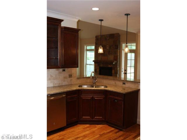 8902 West Pepper Court Oak Ridge, NC 27310 - Photo 5 of 16 Kitchen. The Kitchen and Breakfast are open to the Great Room. Lots of recessed lights and special lighting fixtures are showcased in this home.
