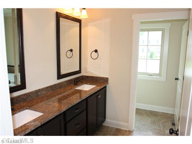 8902 West Pepper Court Oak Ridge, NC 27310 - Photo 7 of 16 Master Bath/Spa. The Master Bath has ample vanity space. Granite countertops are found throughout the home, even in the laundry.