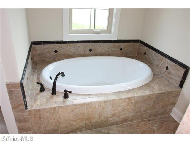 8902 West Pepper Court Oak Ridge, NC 27310 - Photo 8 of 16 Master Bath/Spa. In addition to the oversized shower, there is a large garden tub to soak all of life s cares away.
