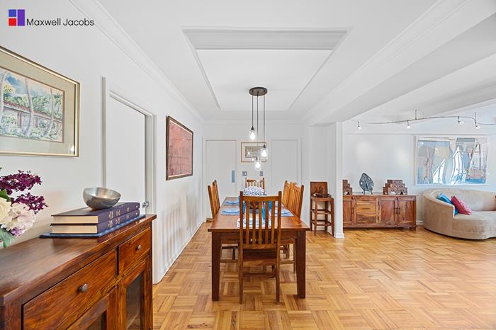 45 West 54th Street, Unit 3C Manhattan, NY 10019 - Photo 3 of 13 a dining room with furniture and window