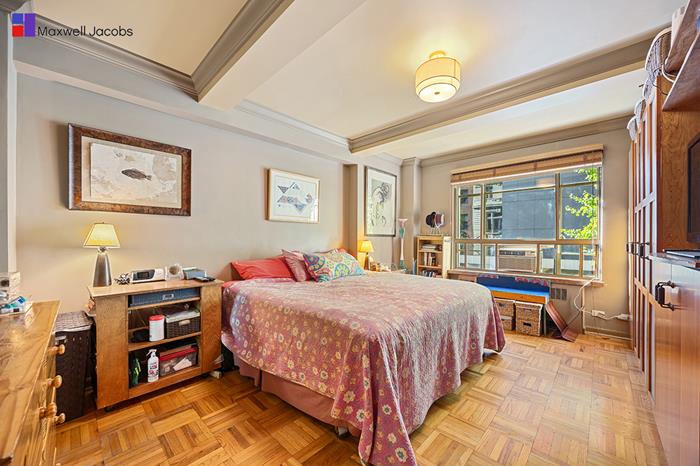 45 West 54th Street, Unit 3C Manhattan, NY 10019 - Photo 5 of 13 a bedroom with a bed and a cabinets