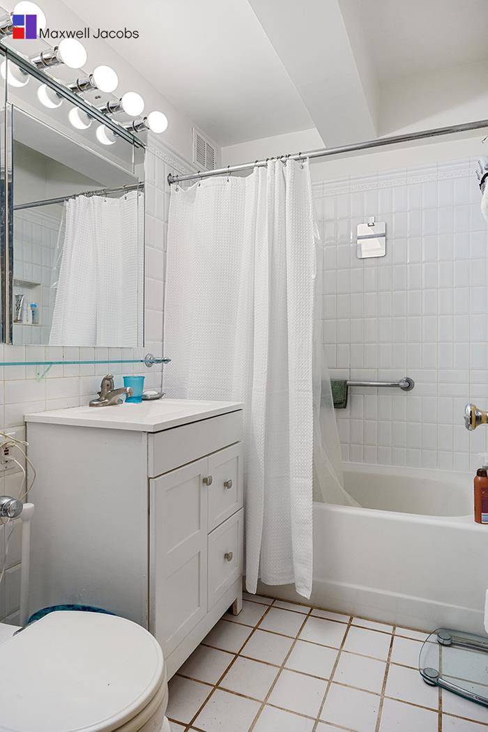 45 West 54th Street, Unit 3C Manhattan, NY 10019 - Photo 6 of 13 a bathroom with a sink a toilet and shower