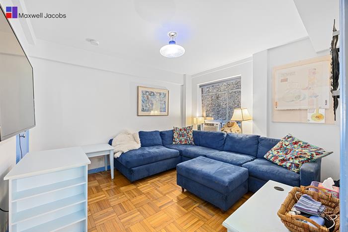 45 West 54th Street, Unit 3C Manhattan, NY 10019 - Photo 7 of 13 a living room with furniture and a potted plant