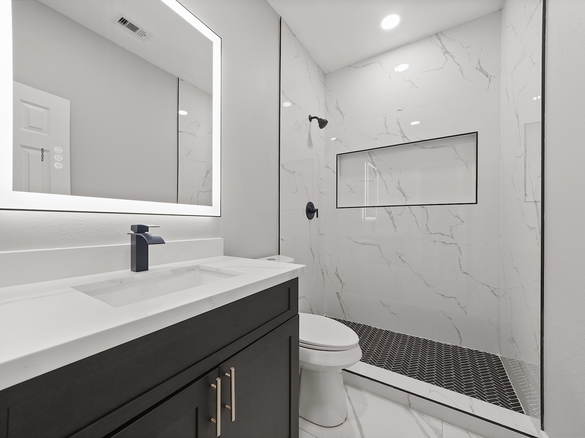 25007 Butterwick Drive Spring, TX 77389 - Photo 12 of 22 a bathroom with a sink toilet a mirror and shower