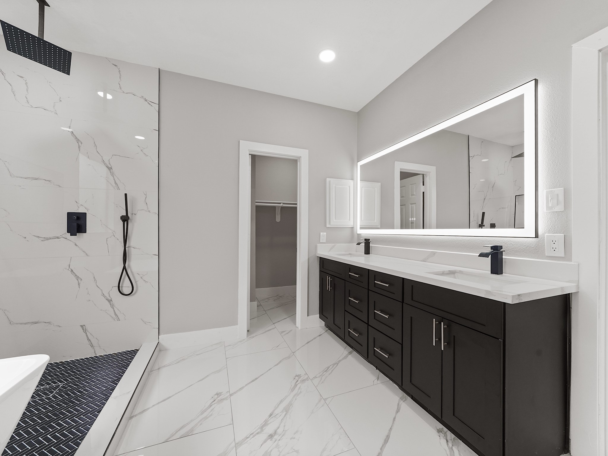 25007 Butterwick Drive Spring, TX 77389 - Photo 16 of 22 a spacious bathroom with a double vanity sink a mirror and a shower