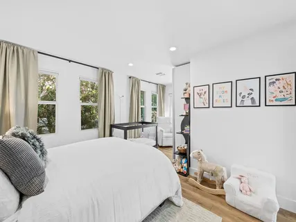 a bedroom with a bed and a large window