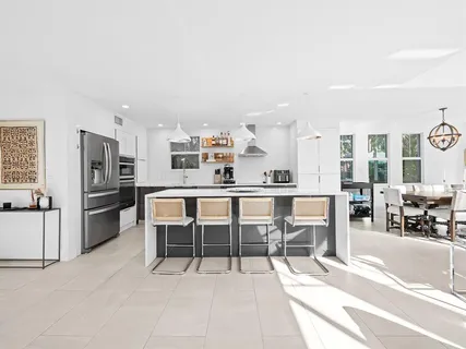a large kitchen with a table and chairs in it