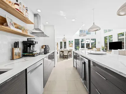 a kitchen with stainless steel appliances granite countertop a sink and cabinets