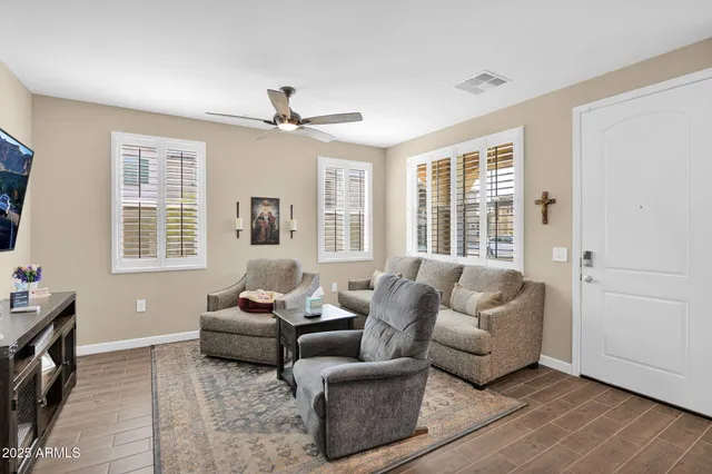 a living room with furniture and large windows