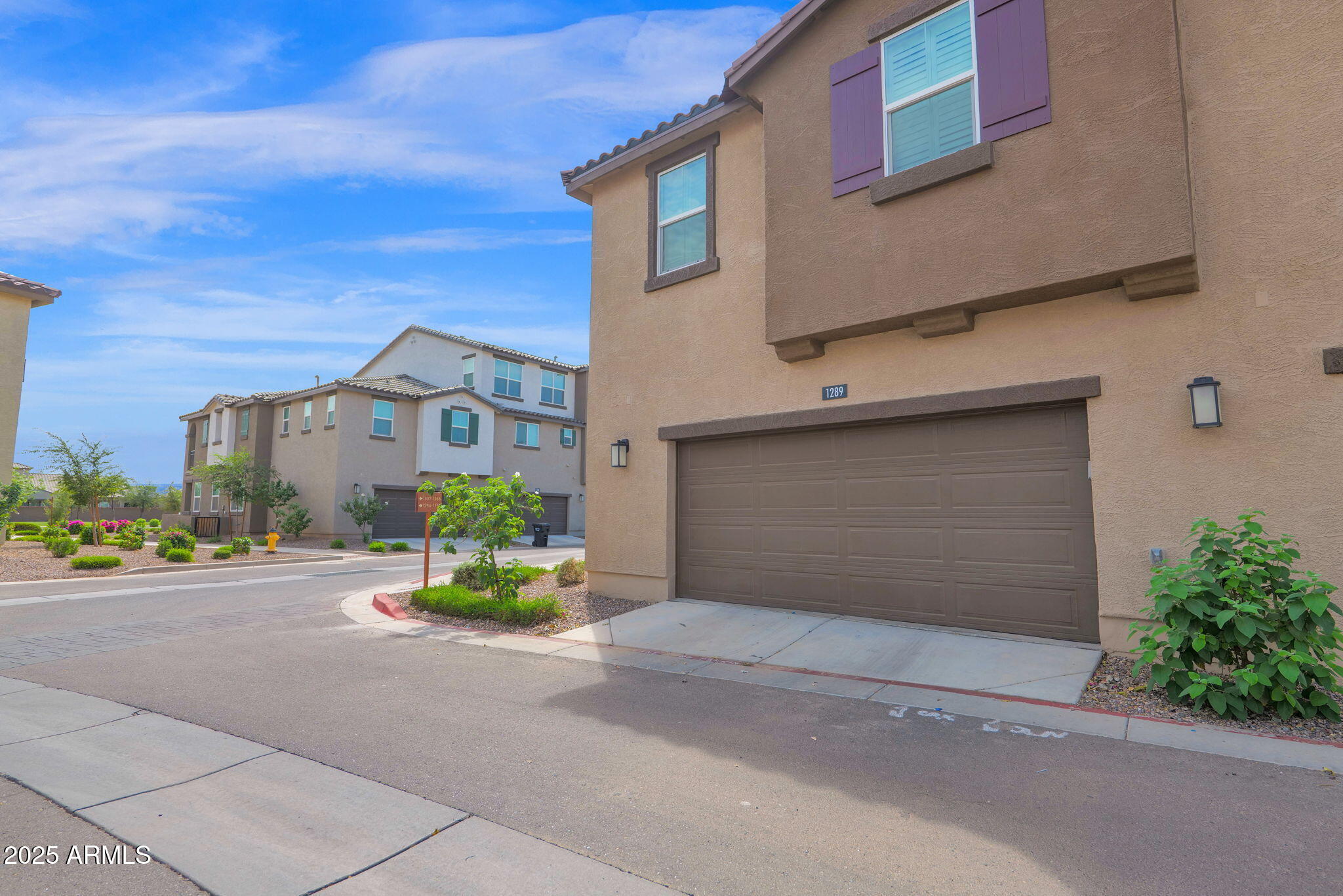 1255 North Arizona Avenue, Unit 1289 Chandler, AZ 85225 - Photo 30 of 32 a front view of a house with a yard and garage