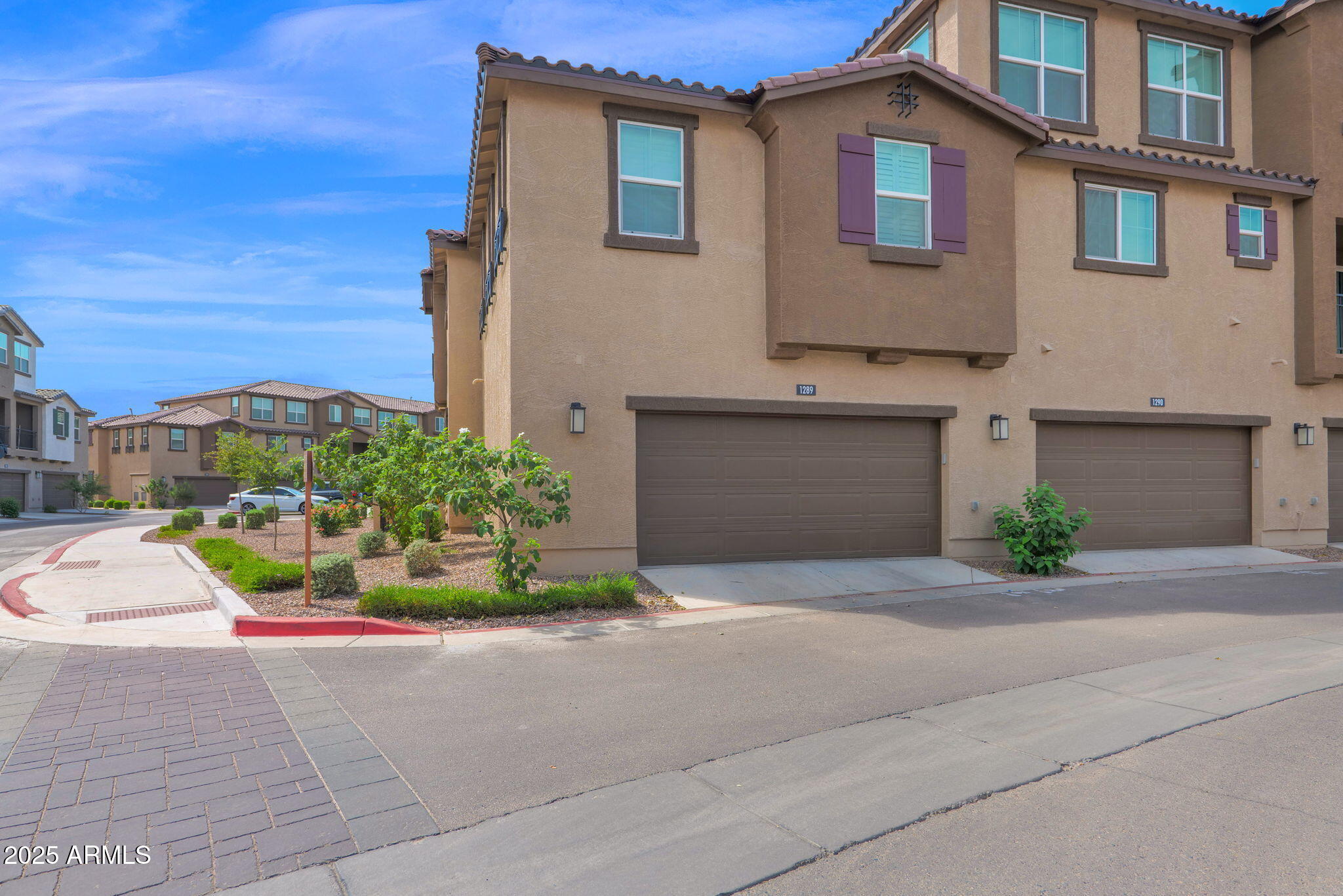 1255 North Arizona Avenue, Unit 1289 Chandler, AZ 85225 - Photo 3 of 32 a front view of a house with a yard and garage