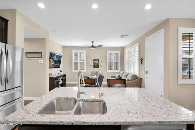 a kitchen with granite countertop a sink and a refrigerator