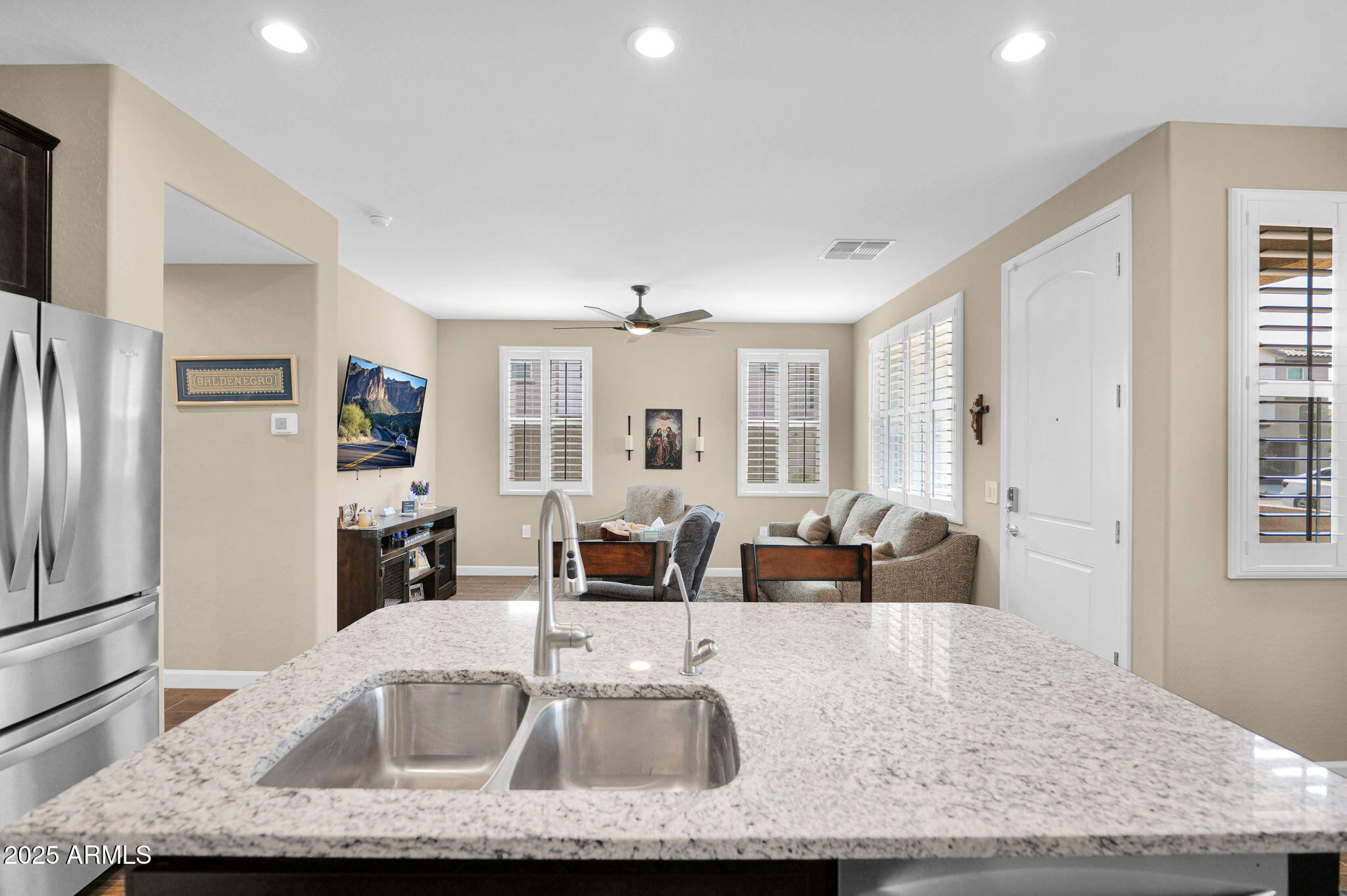 1255 North Arizona Avenue, Unit 1289 Chandler, AZ 85225 - Photo 5 of 32 a kitchen with granite countertop a sink and a refrigerator