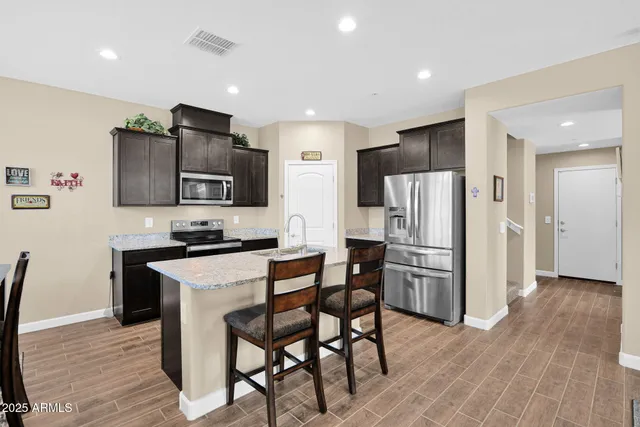 a kitchen with stainless steel appliances a refrigerator stove microwave and cabinets
