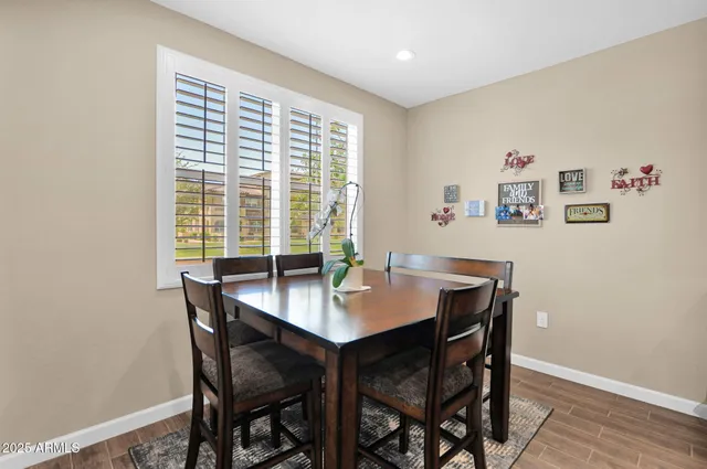 a view of a dining room with a table and chairs