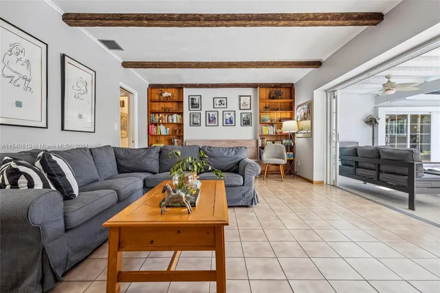 a spacious bedroom with a bed and wooden floor