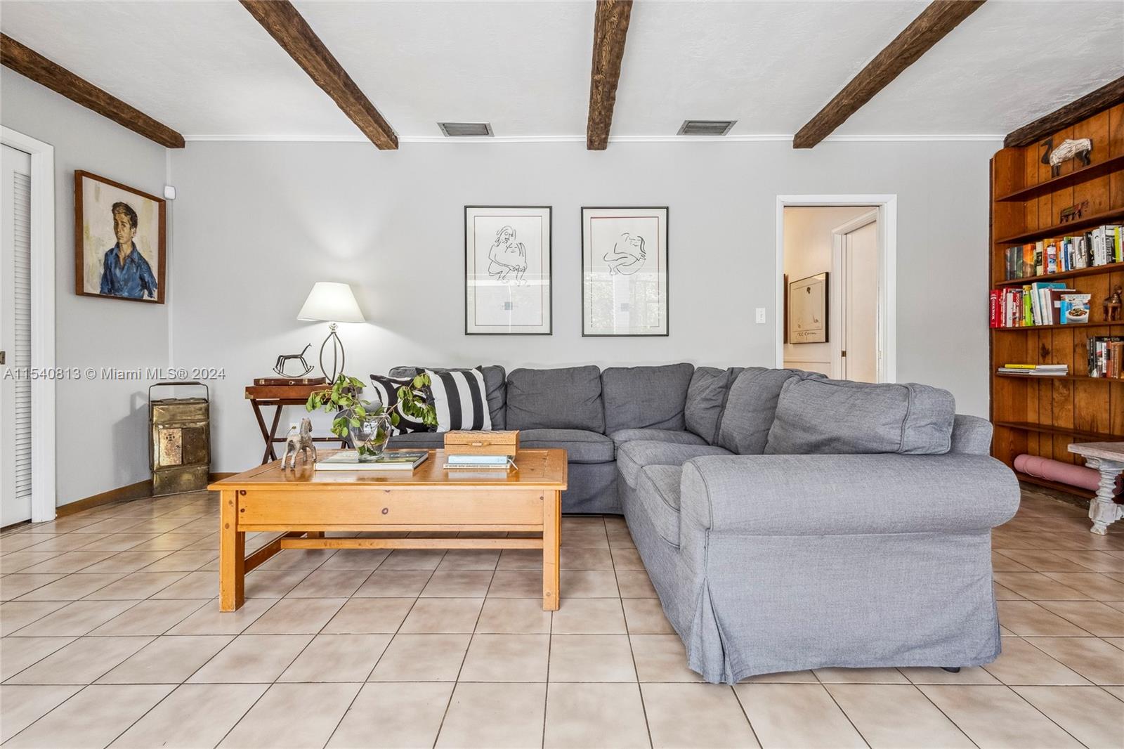 10130 Southwest 70th Avenue Pinecrest, FL 33156 - Photo 18 of 75 a living room with furniture and a book shelf