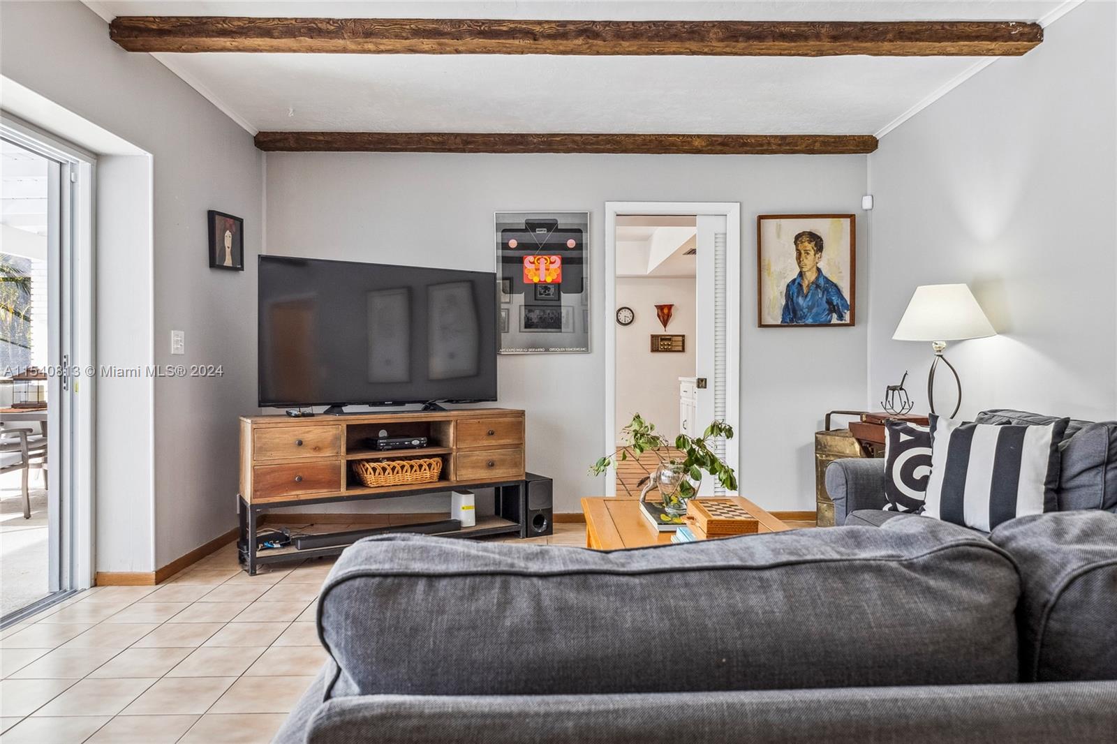 10130 Southwest 70th Avenue Pinecrest, FL 33156 - Photo 19 of 75 a living room with furniture and a flat screen tv