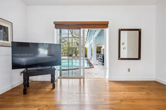 a large bed sitting in a bedroom next to a window