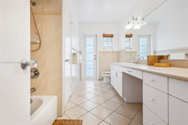 a bedroom with a bed and a wall painting