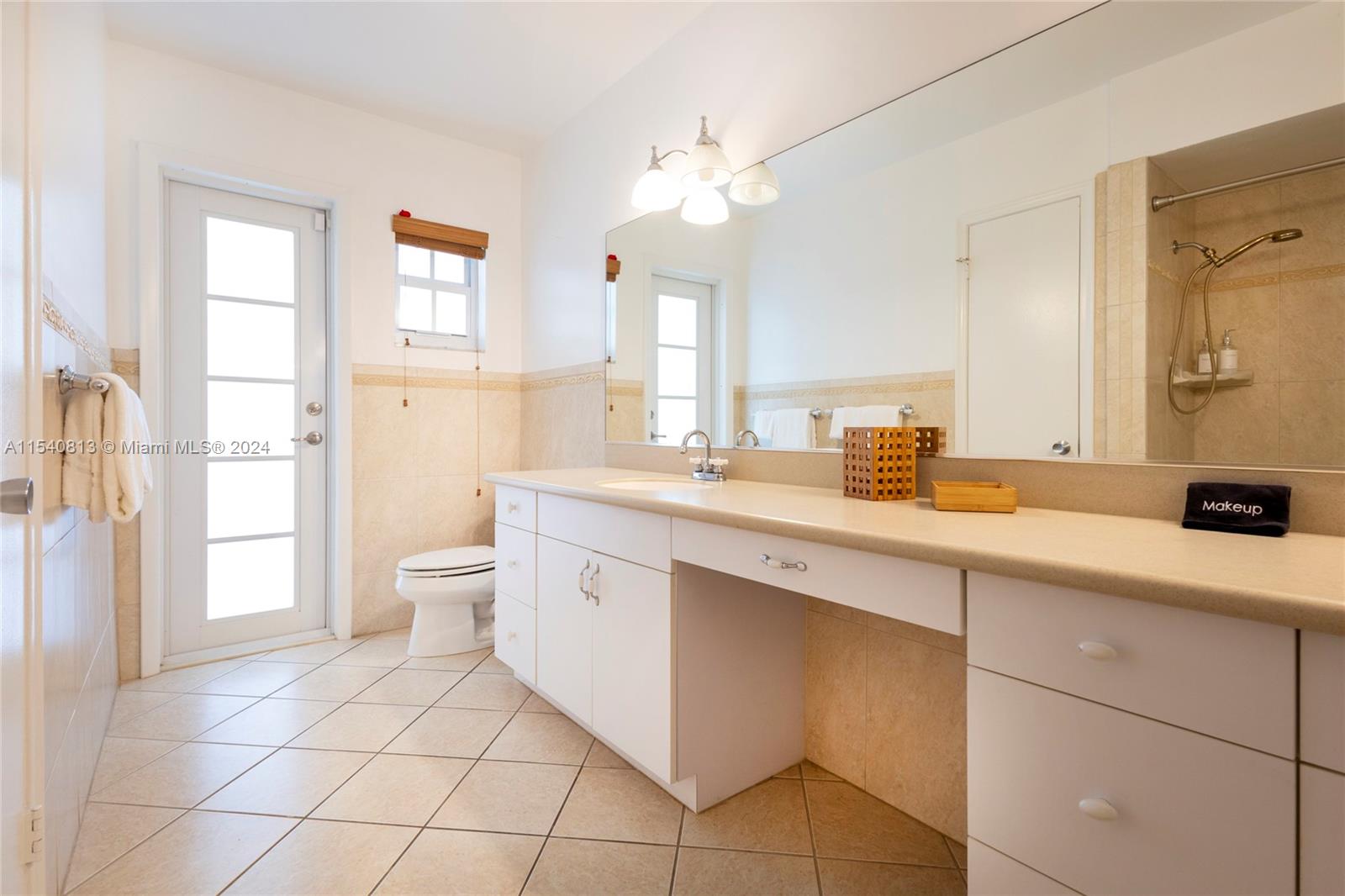 10130 Southwest 70th Avenue Pinecrest, FL 33156 - Photo 31 of 75 a spacious bathroom with a double vanity sink mirror and