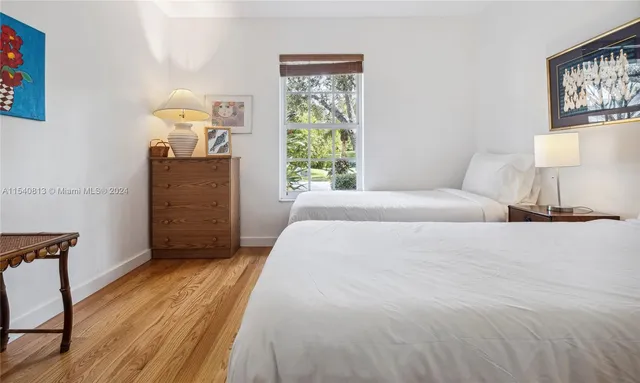 a bedroom with a bed and wall painting