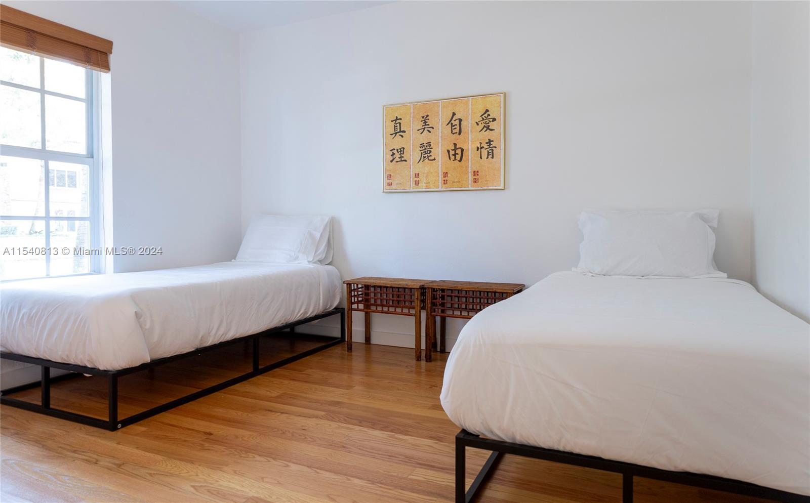 10130 Southwest 70th Avenue Pinecrest, FL 33156 - Photo 36 of 75 a bed sitting in a bedroom next to a window