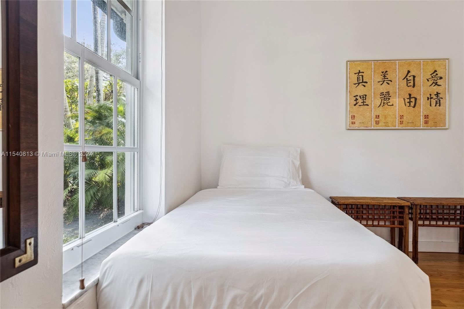 10130 Southwest 70th Avenue Pinecrest, FL 33156 - Photo 37 of 75 a large bed sitting in a bedroom next to a window