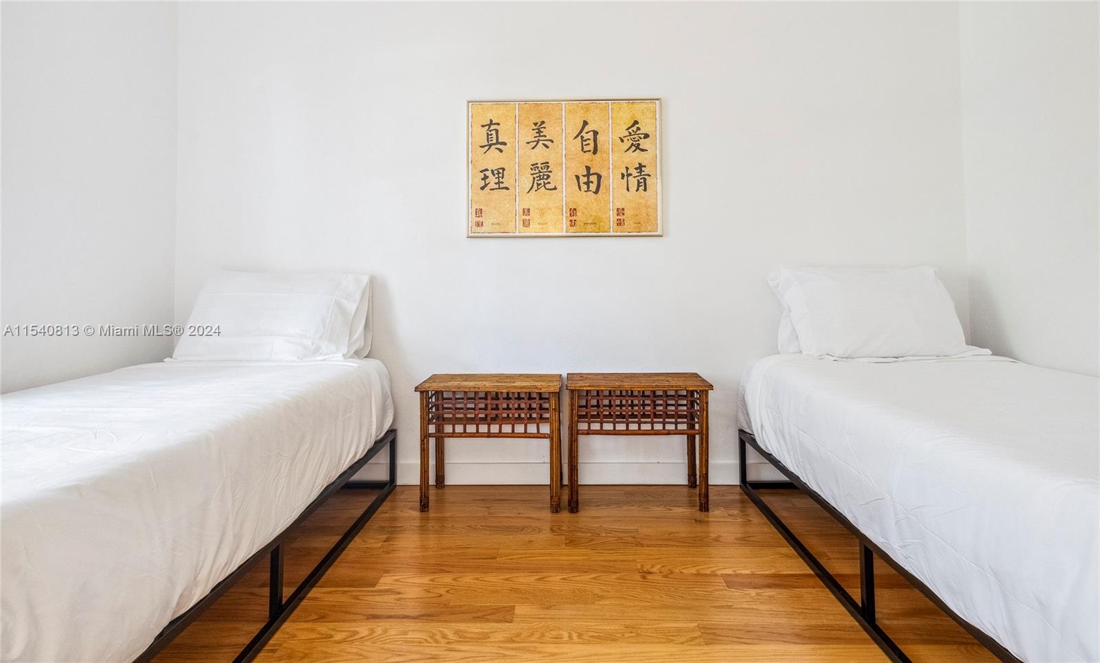 10130 Southwest 70th Avenue Pinecrest, FL 33156 - Photo 39 of 75 a bedroom with a bed and a wall painting