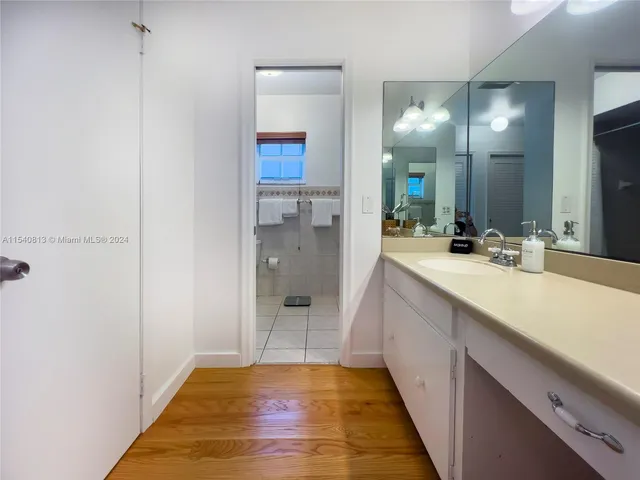 a living room with furniture a flat screen tv and a floor to ceiling window