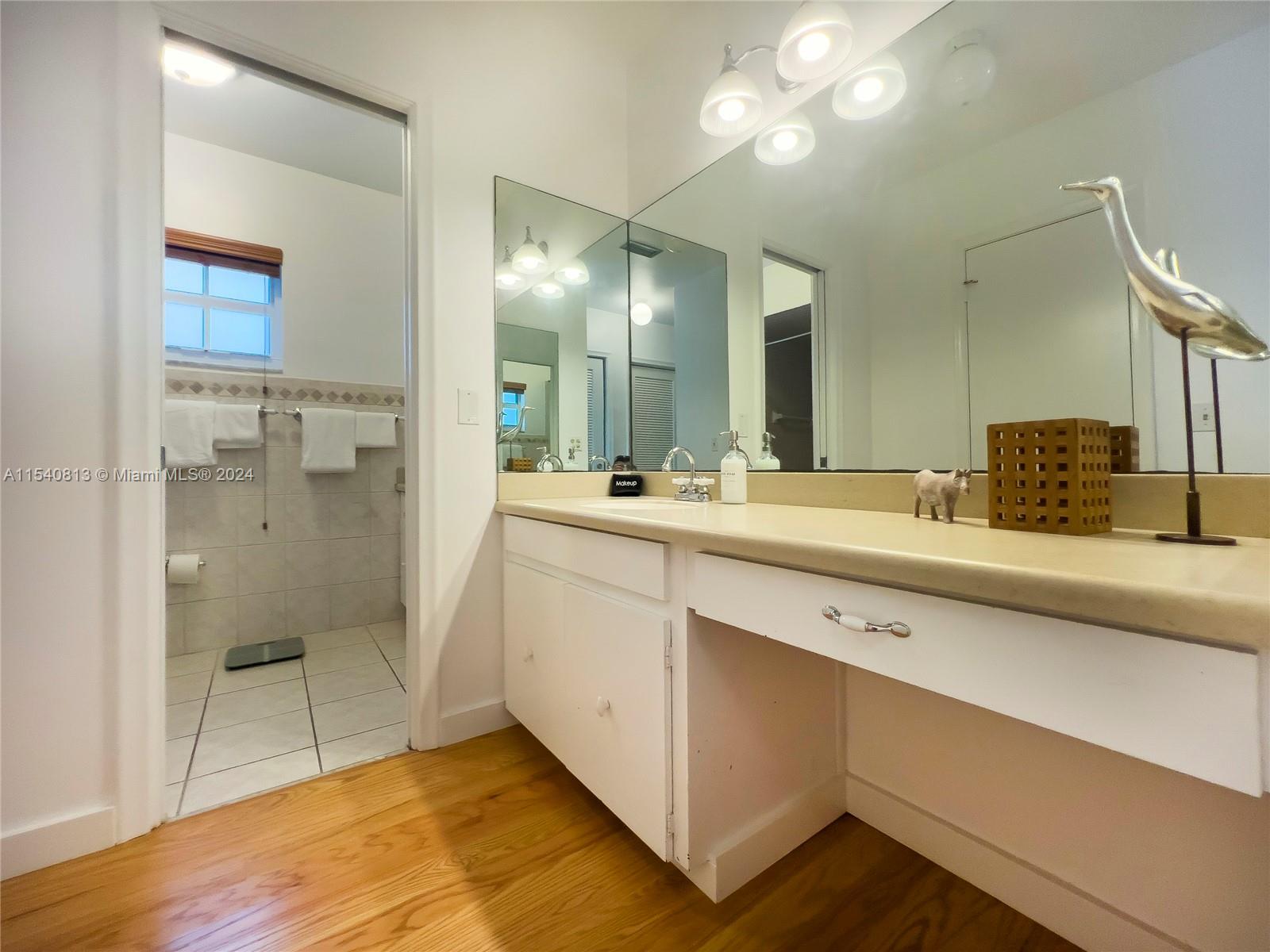 10130 Southwest 70th Avenue Pinecrest, FL 33156 - Photo 46 of 75 a bathroom with a double vanity sink mirror and shower