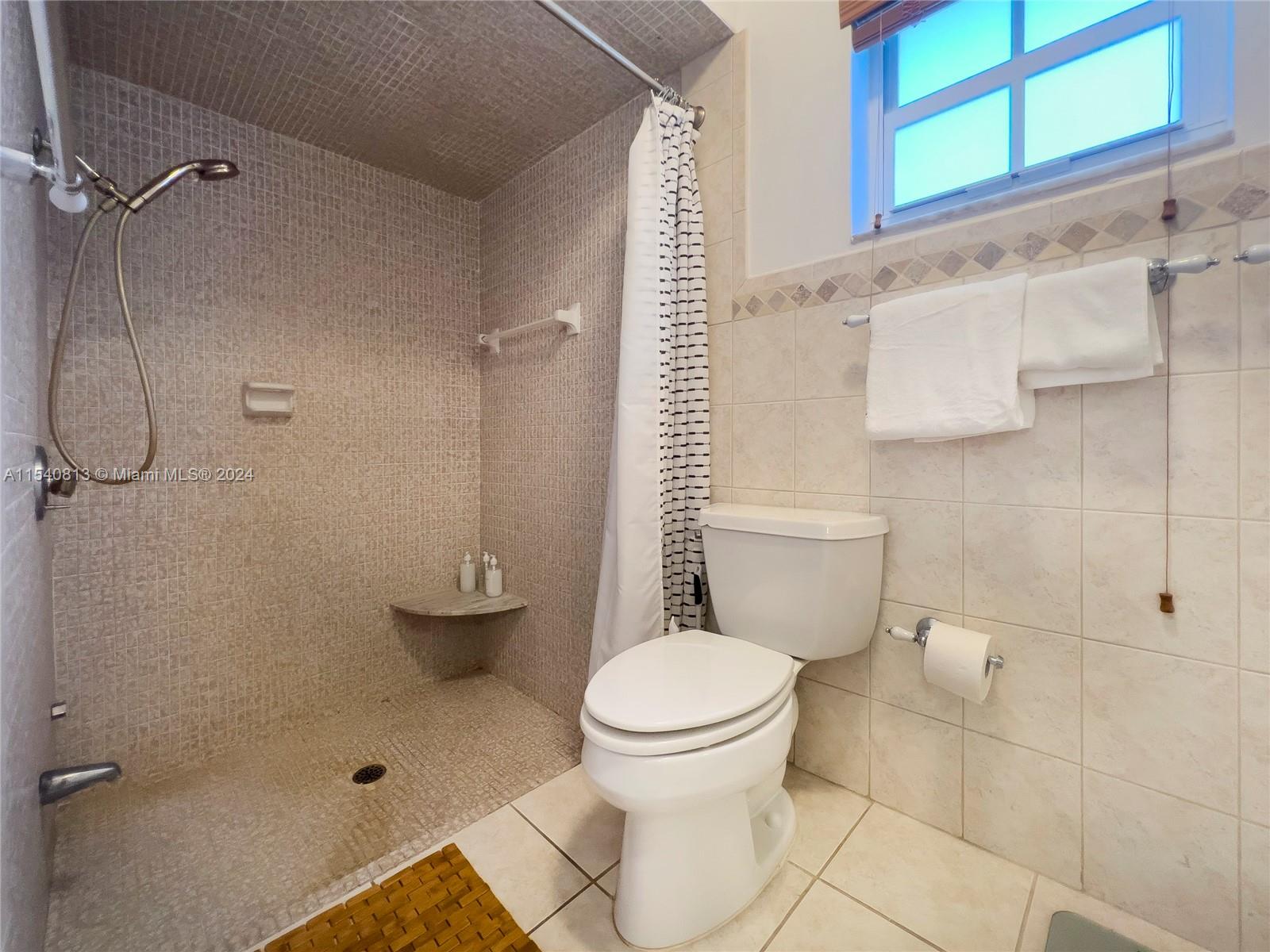 10130 Southwest 70th Avenue Pinecrest, FL 33156 - Photo 48 of 75 a bathroom with a toilet and a shower