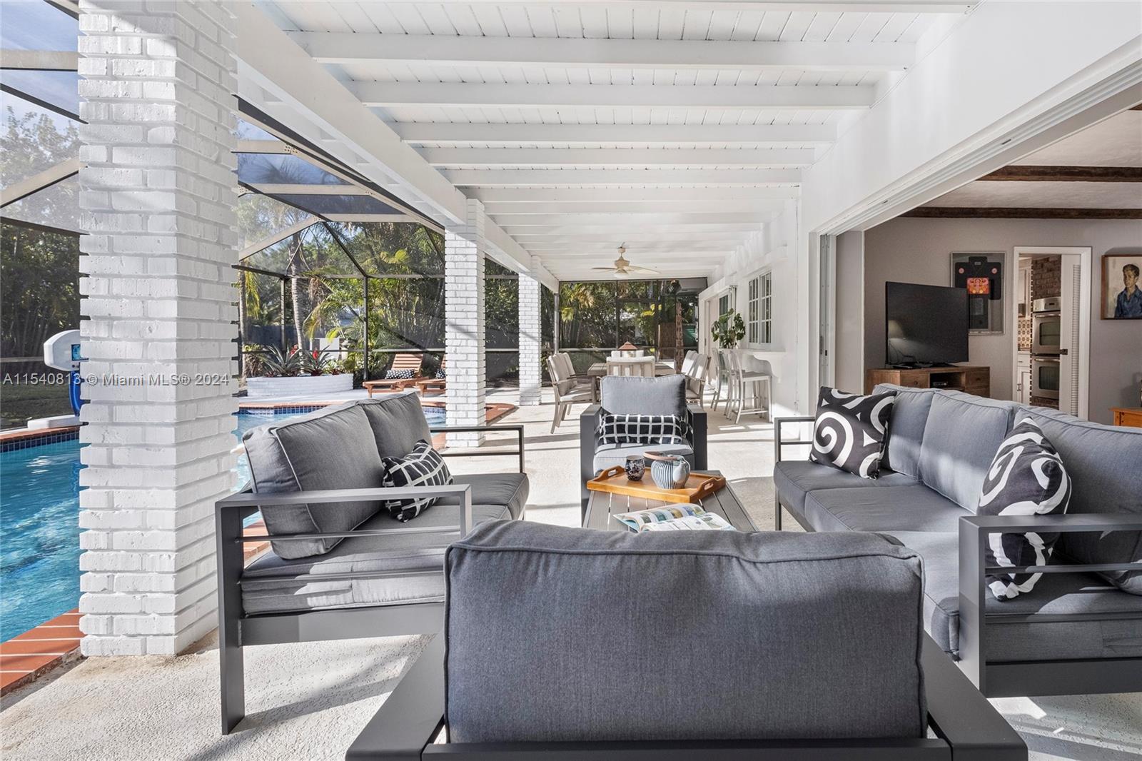 10130 Southwest 70th Avenue Pinecrest, FL 33156 - Photo 54 of 75 a living room with furniture and a flat screen tv
