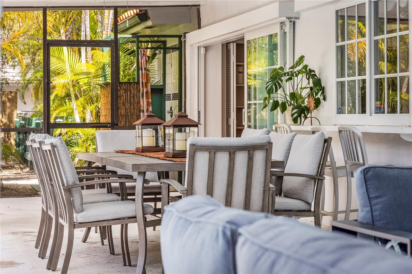 10130 Southwest 70th Avenue Pinecrest, FL 33156 - Photo 55 of 75 a view of a dining room with furniture window and wooden floor